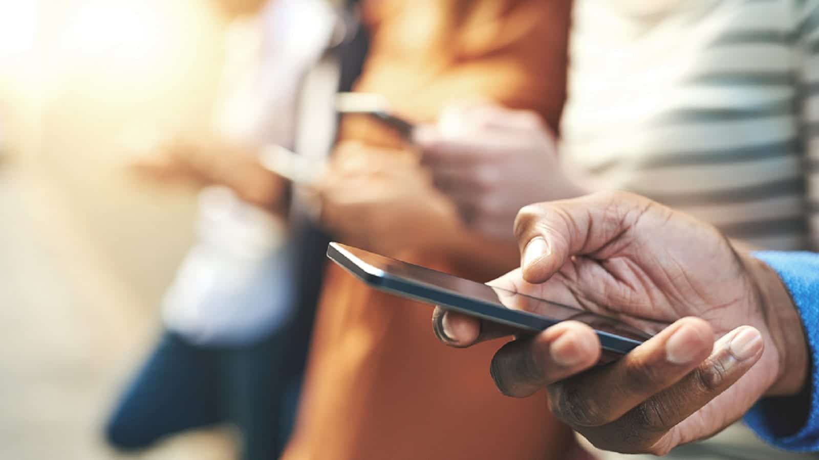 Man Texting On A Smartphone Stock Photo