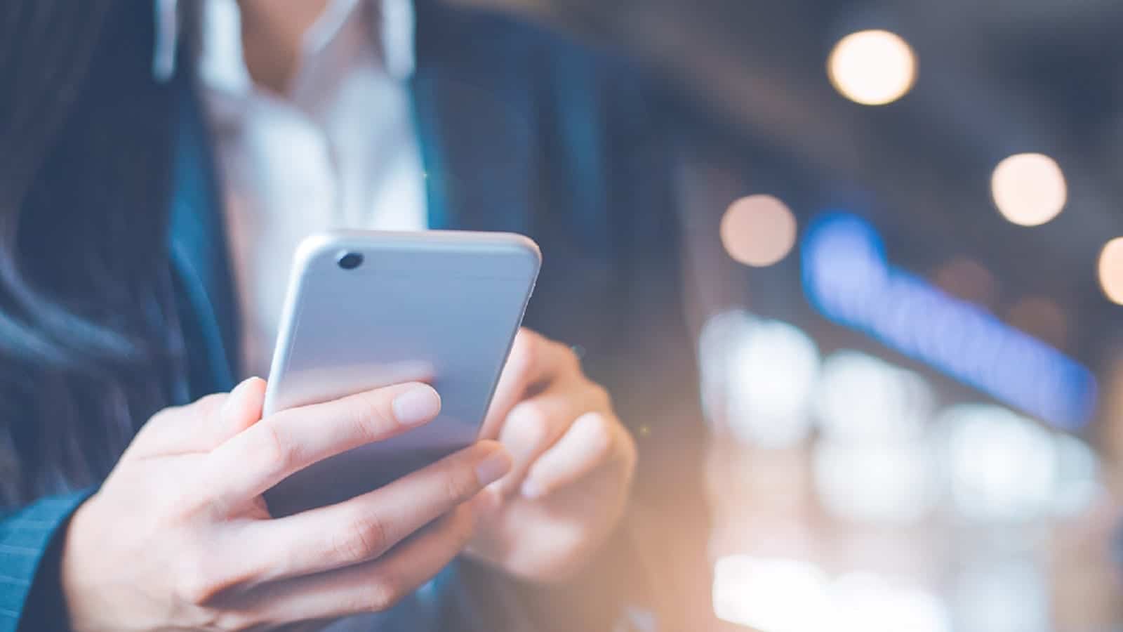 Young Woman Making A Phone Call On Mobile Device Stock Photo